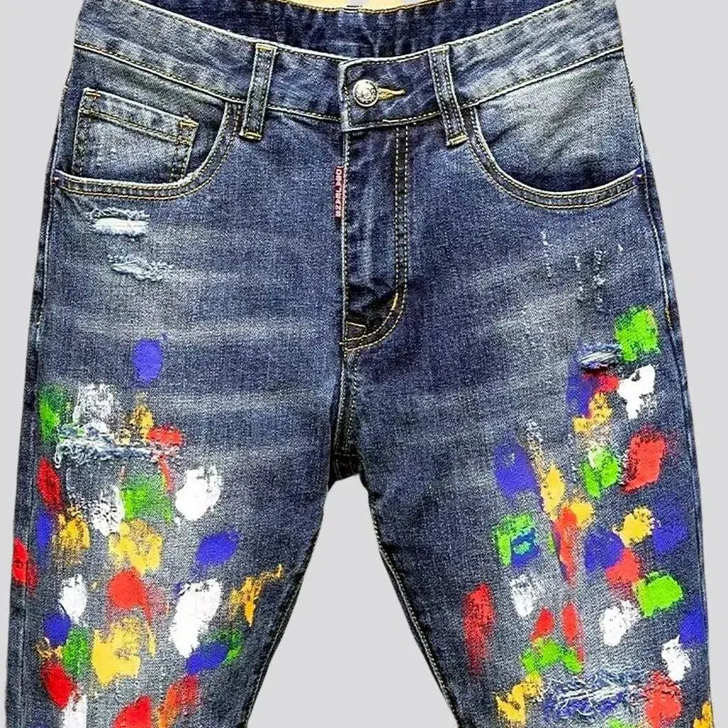 Multi-color stains sanded jeans