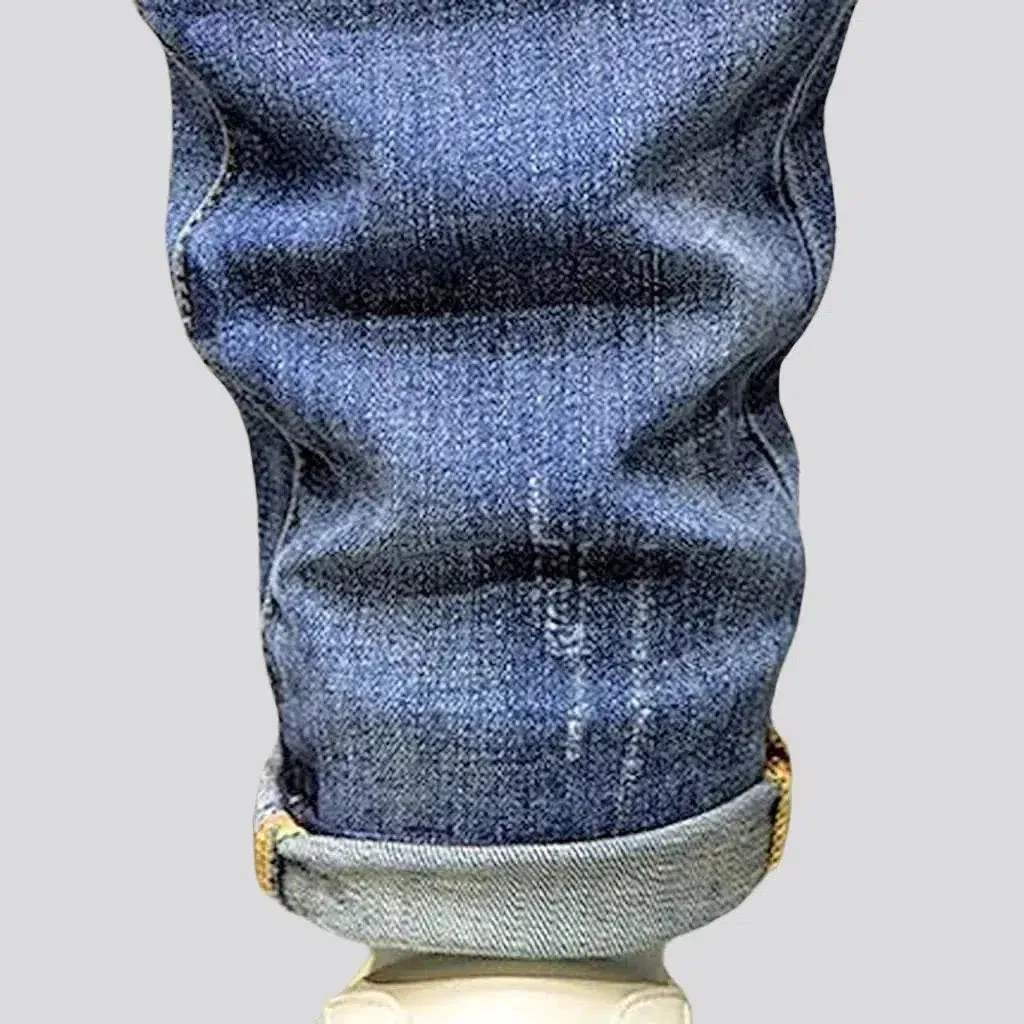 Multi-color stains sanded jeans